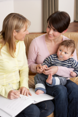 image of a midwife working with a new mother and toddler